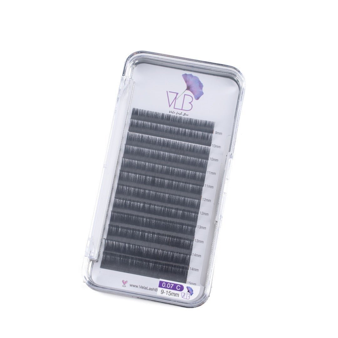 Vela Lash Bar C lash extensions tray with varying lengths of black false lashes in clear case